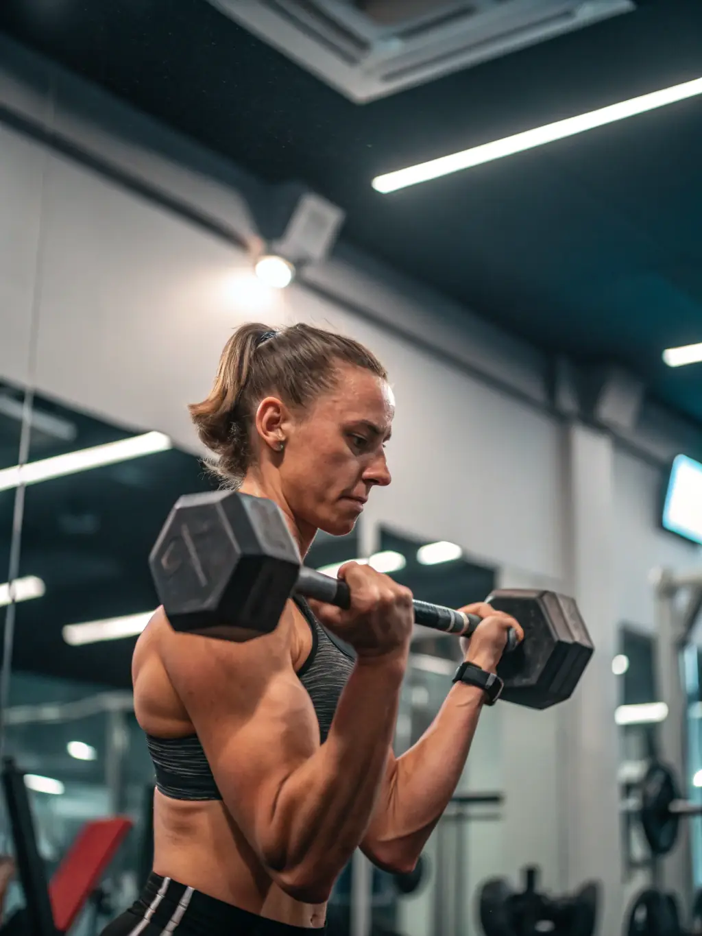 A person with diabetes exercising with a trainer in a gym, focusing on strength training, demonstrating personalized care and attention.